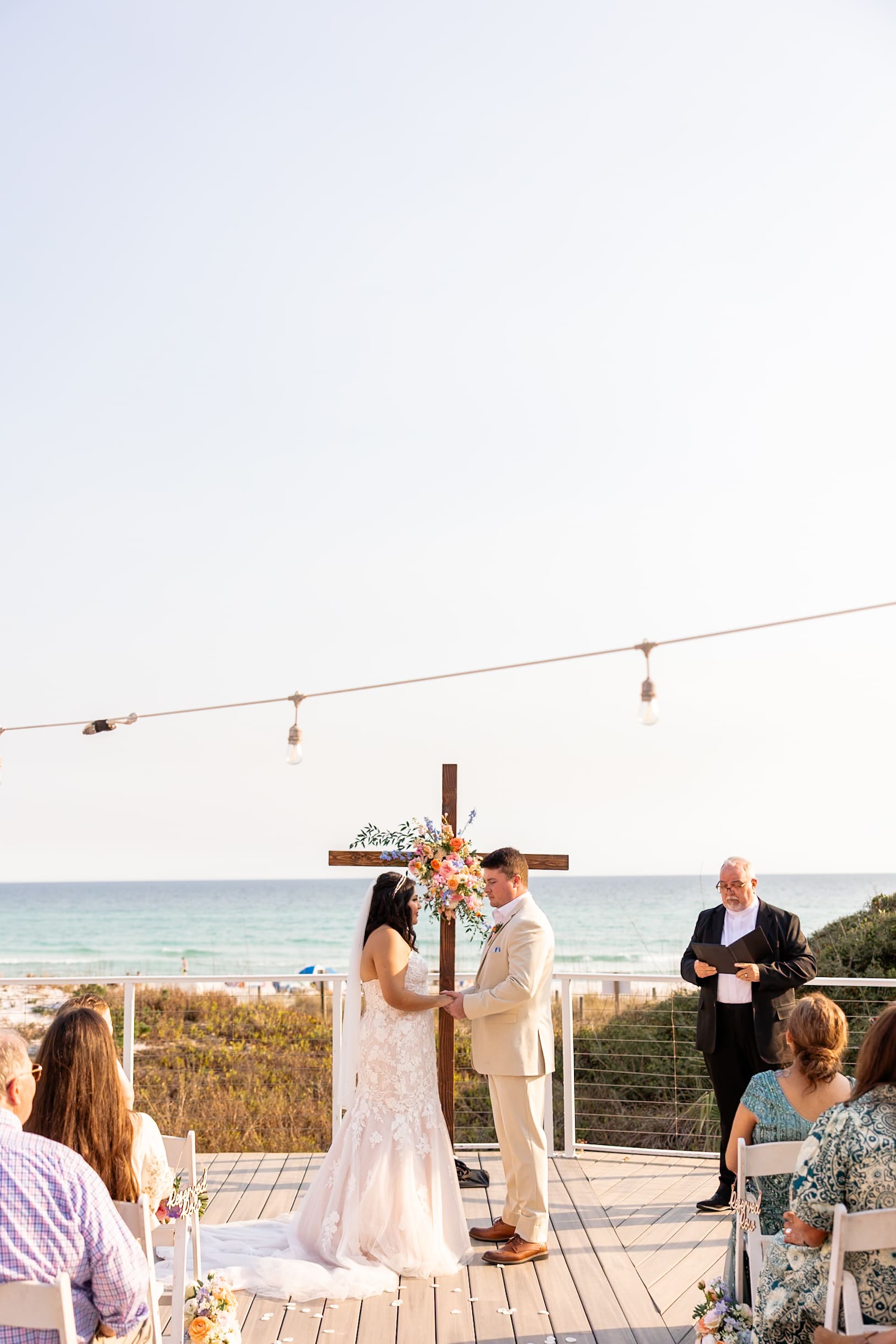 Intimate "I dos" between bride and groom in front of beachside view at destination wedding | Madison Abernathy Photography
