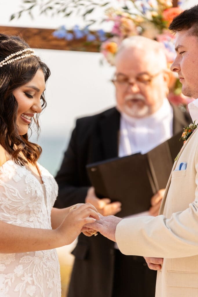 Bride and groom at beach wedding exchanging rings | Madison Abernathy Photography