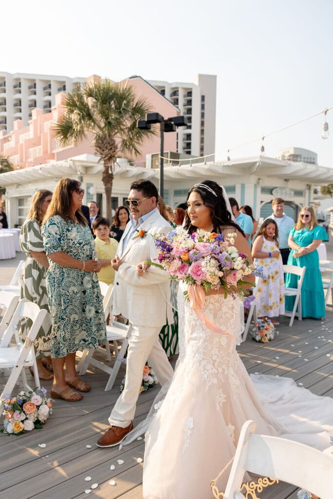 Father walking the bride down the aisle for her bright beachside vintage floral wedding | Madison Abernathy Photography