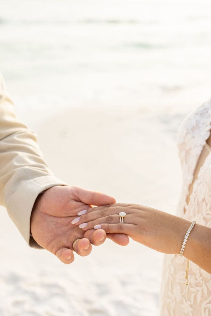 Groom holding wife's hand on a beach in Florida | Madison Abernathy Photography
