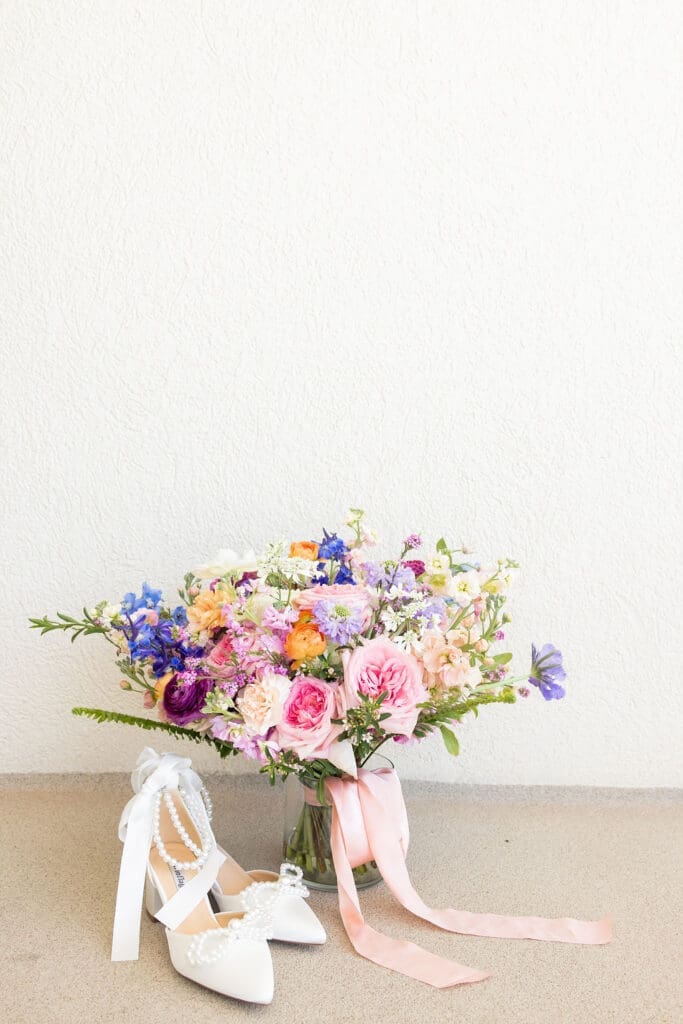 Bright floral bouquet paired with vintage wedding shoes | Madison Abernathy Photography